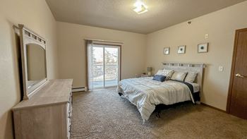 a bedroom with a bed and a dresser and a window